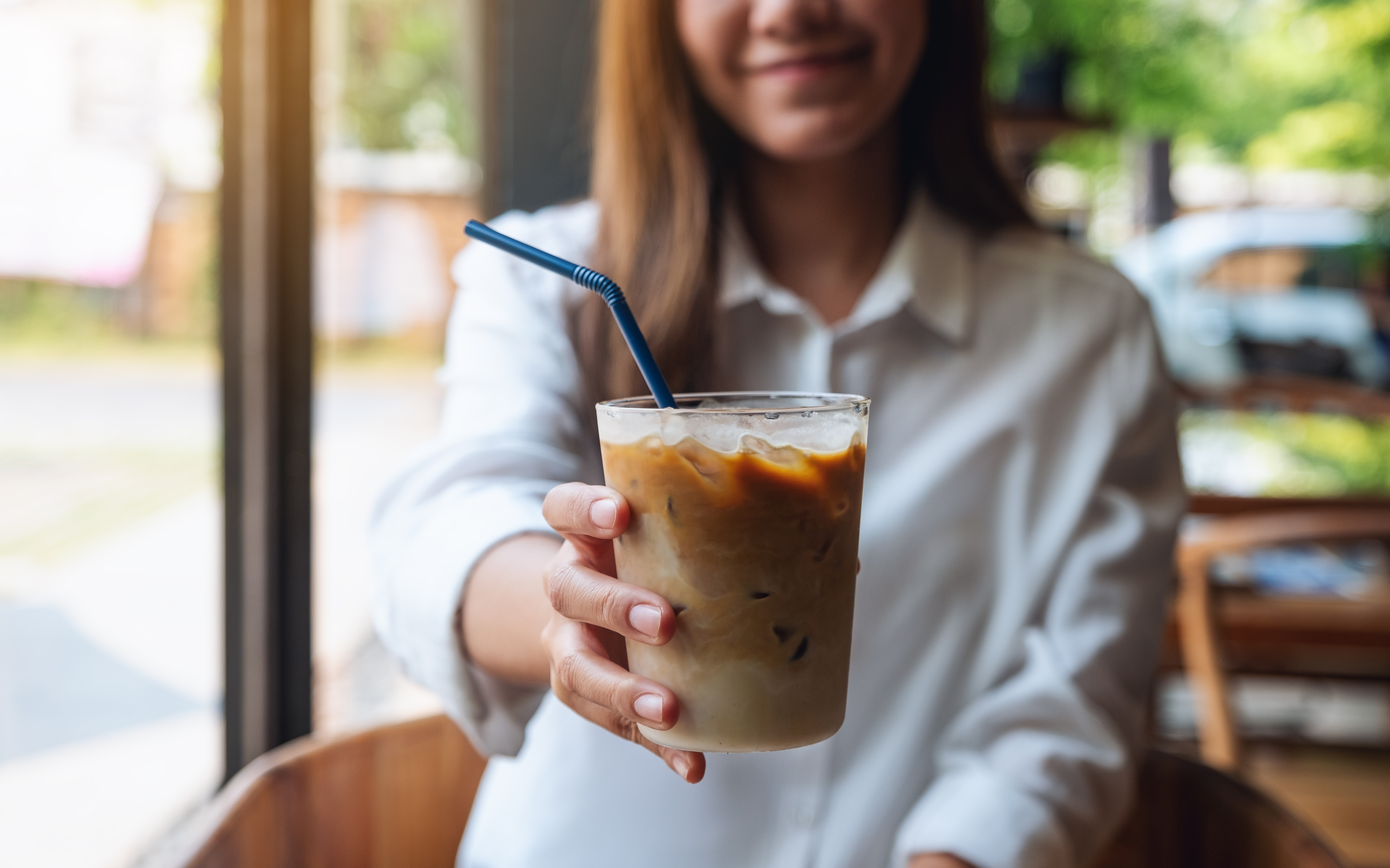 Photograph of the Carrion menu item in a glass cup being held by a woman.